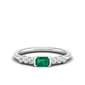 East-West Emerald and Bezel Diamond Ring