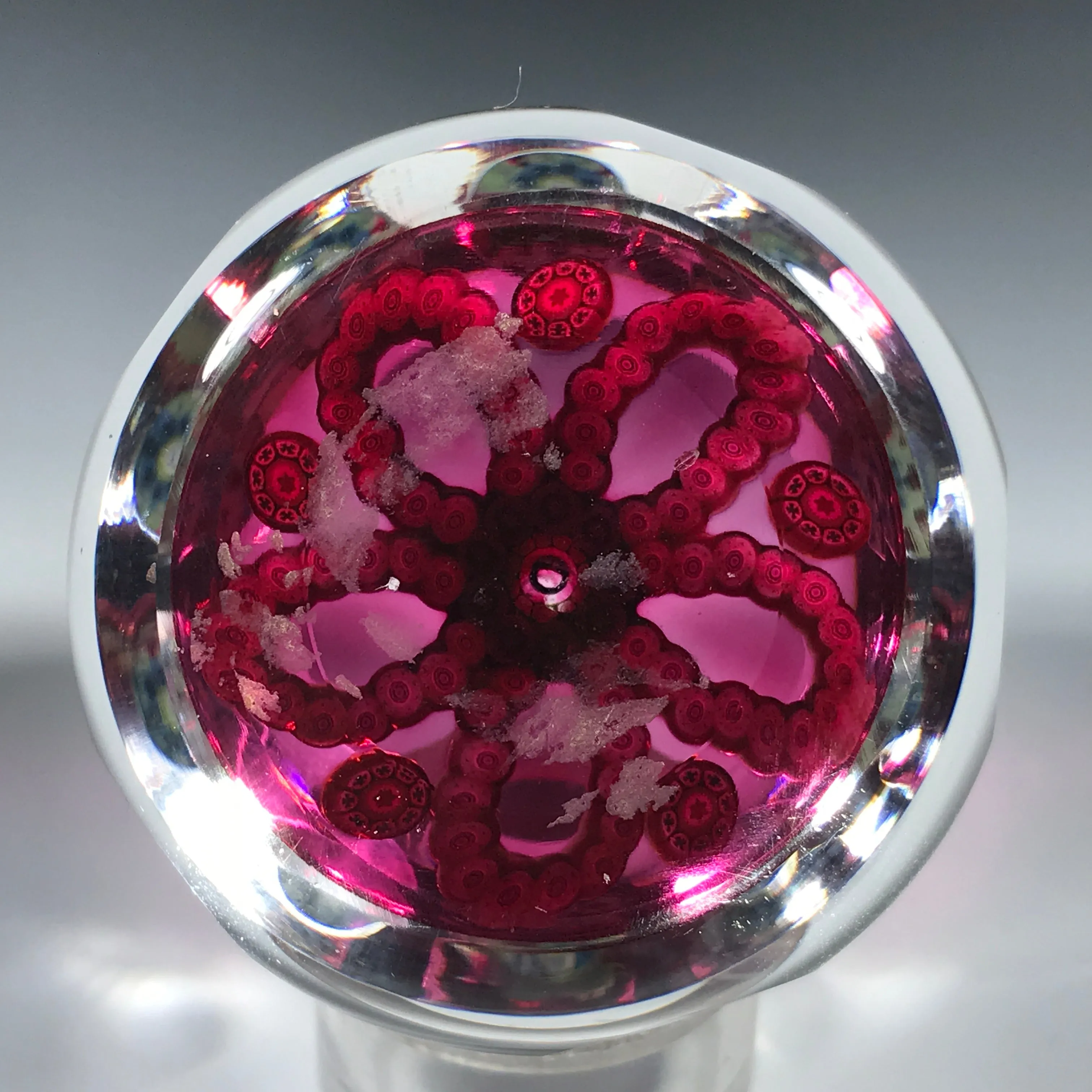 Faceted Perthshire 1983 "O" Glass Paperweight Patterned Complex Millefiori Garlands on Transparent Ruby Ground