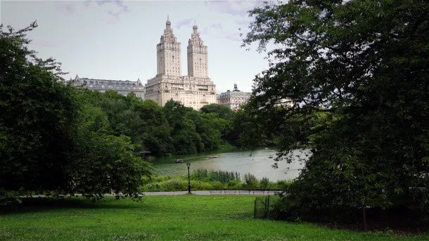 People Walk Near The Lake in Central Park NYC